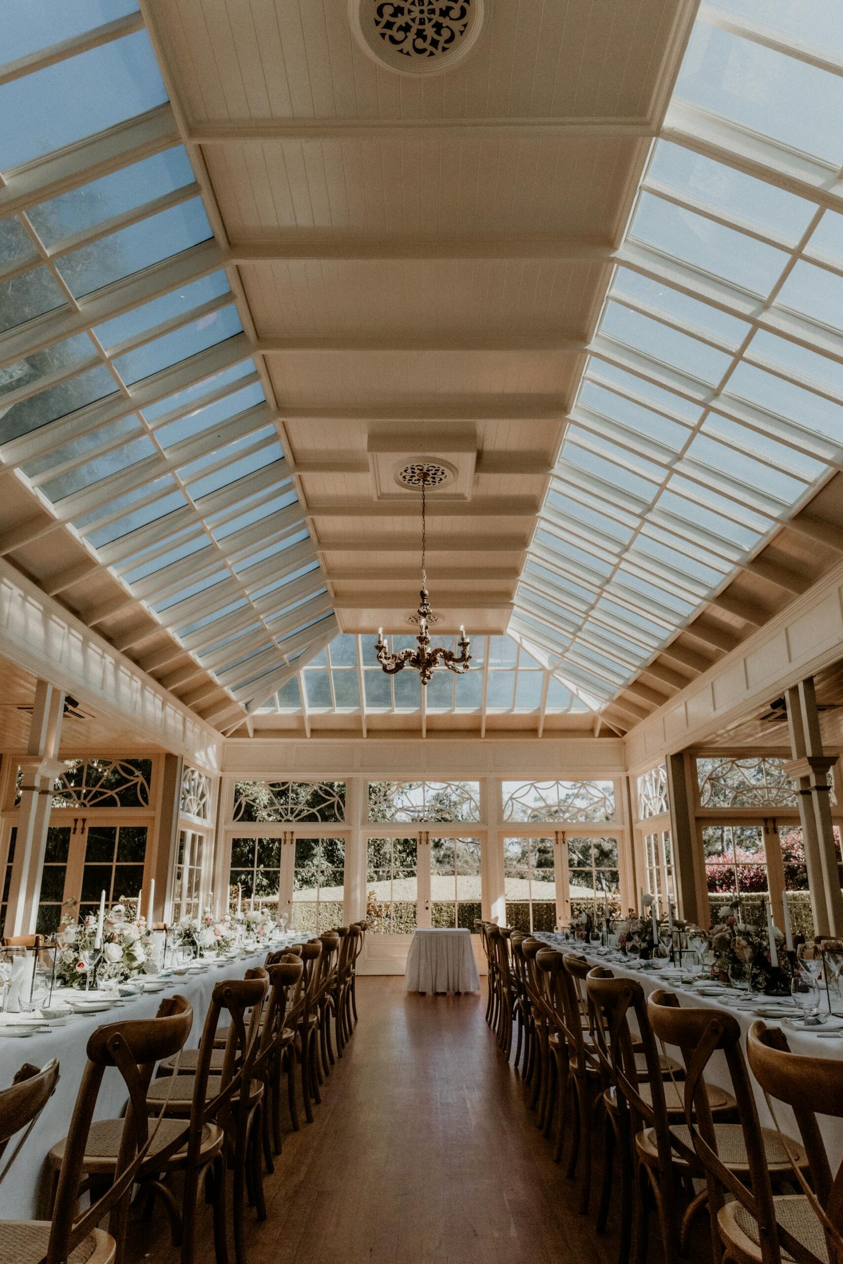 A spacious function venue with long tables and chairs set for a wedding or celebration.