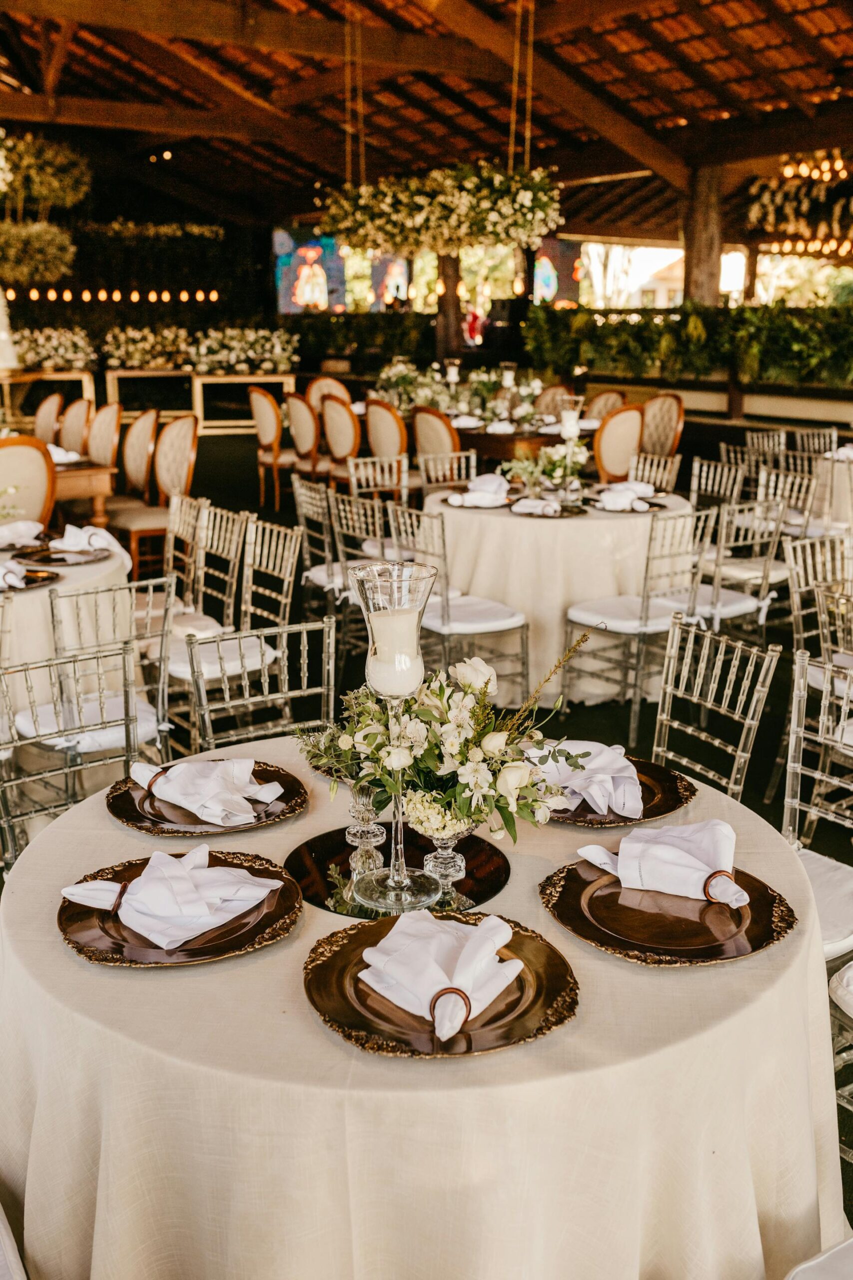 A well-decorated function venue with tables covered in white cloth, ready for a special event.