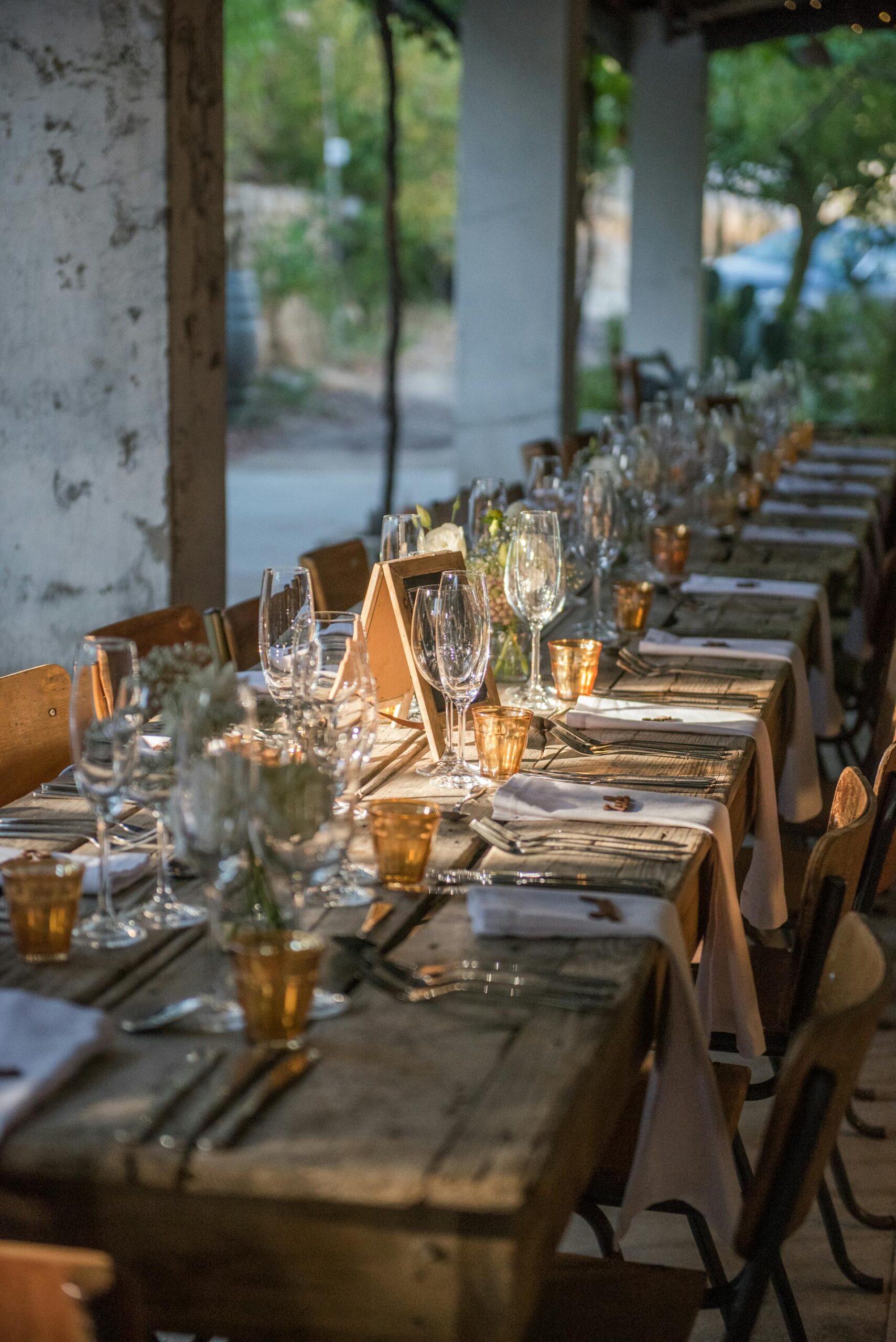 A beautifully decorated long table in a function venue, set for a celebration or special event.