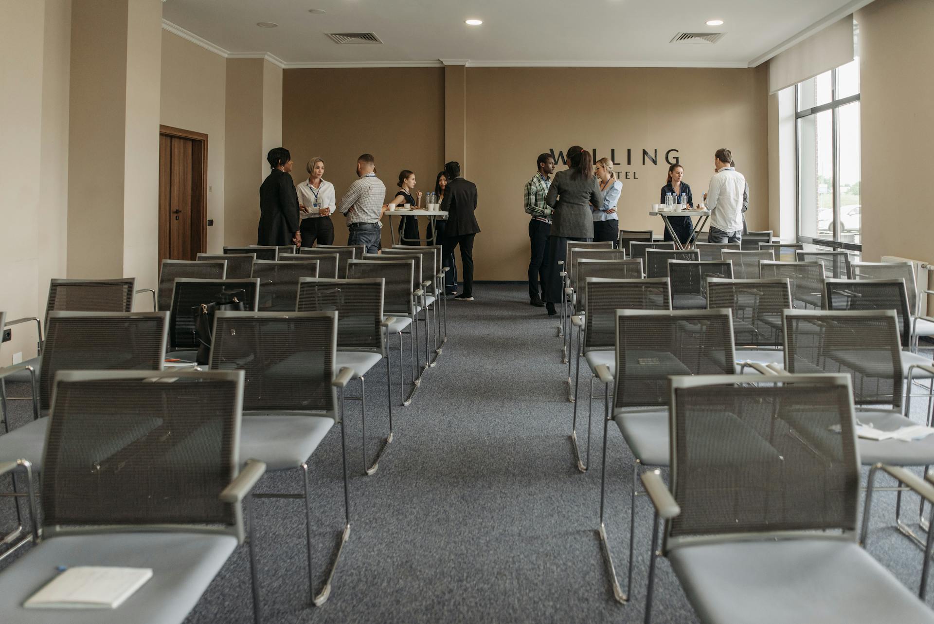 A modern function venue with a group of people networking in a stylish function room.