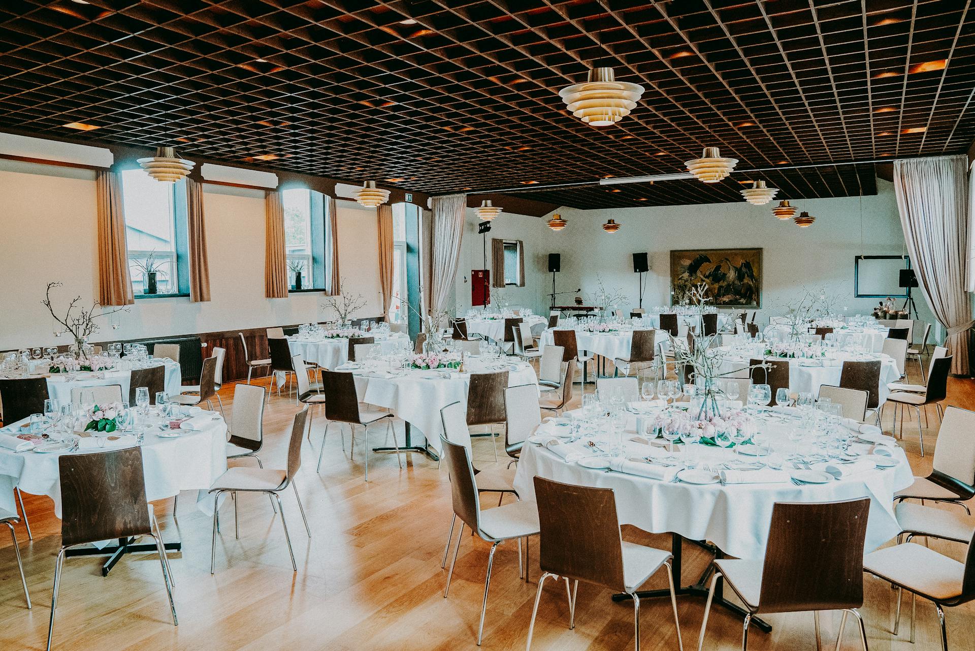 Elegant function venue with beautifully arranged tables and chairs, perfect for weddings, corporate events, and celebrations.