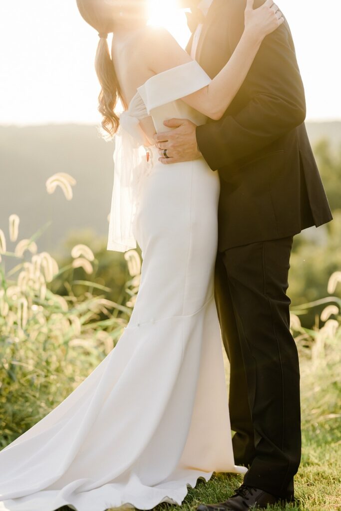 A newlywed couple embracing at a beautiful wedding venue, celebrating their love in a romantic setting.