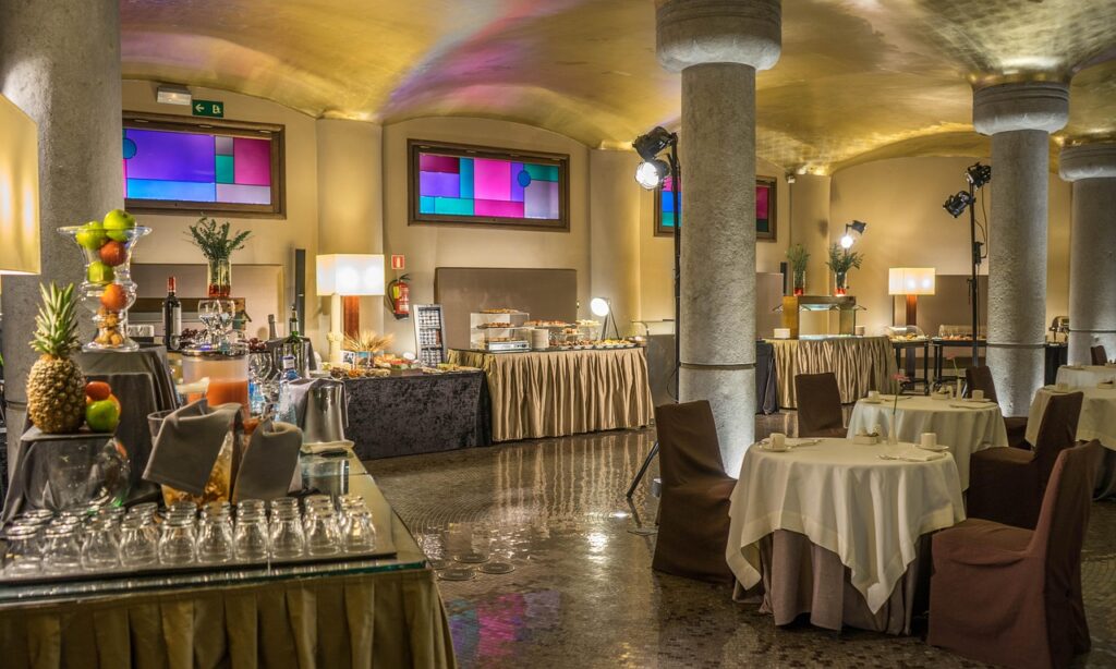 A large, open conference room with tables and chairs, ideal for business events, networking sessions, and corporate meetings.