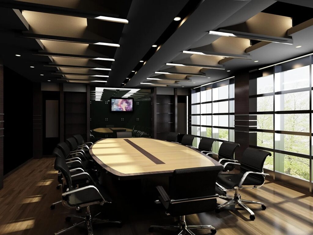 A spacious conference room featuring a large table and chairs, designed for business meetings and corporate gatherings.